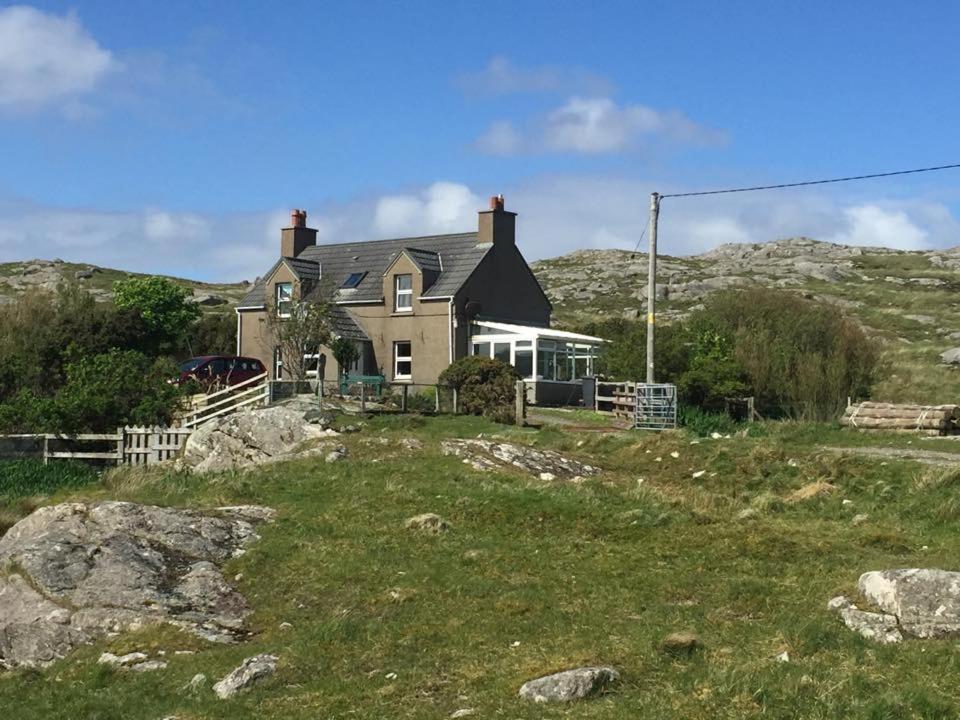 a house on top of a hill with a grass field at George's House - 1 Leacklee in Manish