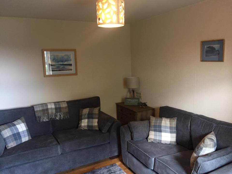a living room with two couches and a lamp at George's House - 1 Leacklee in Manish