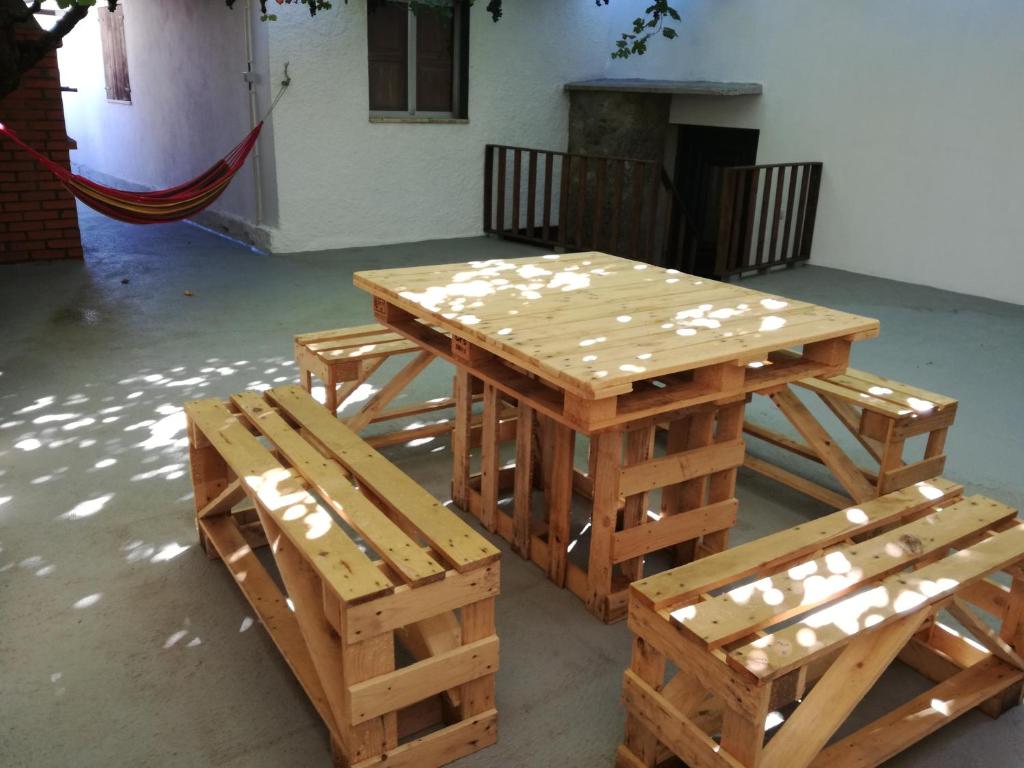 a wooden picnic table and bench in a room at Casa de Paulus - Gerês in Geres