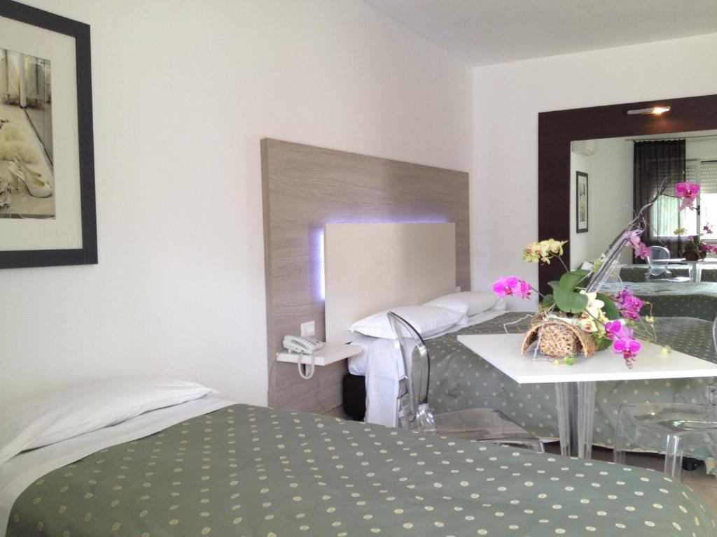 Postel nebo postele na pokoji v ubytování Hotel Ambrosio La Corte