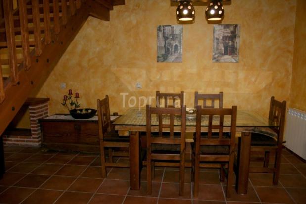 a dining room with a table and chairs at casa rural EL RINCON in Navadijos