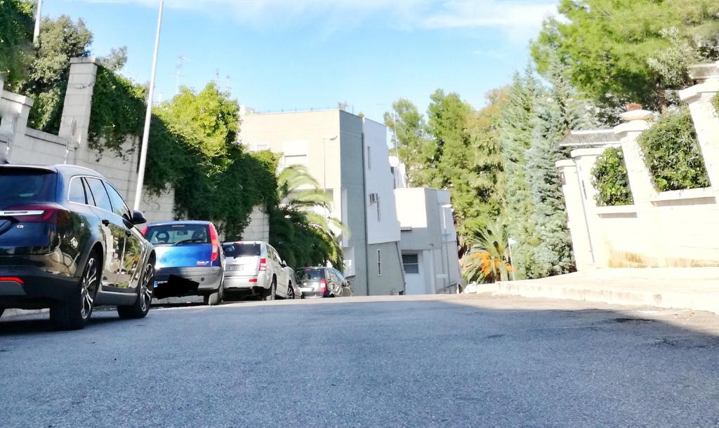 a group of cars parked on the side of a street at Borgo San Gaetano in Bernalda