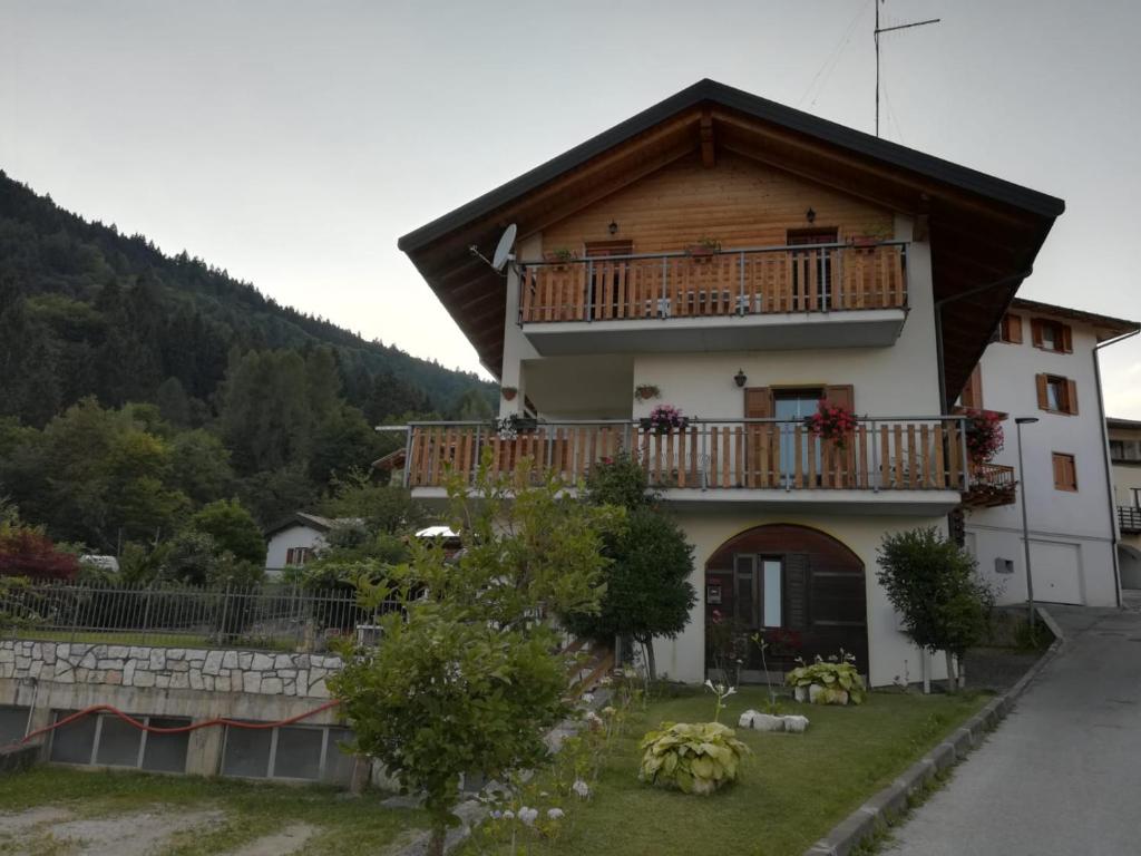 a house with a balcony on the side of it at Casa Relax in Pergine Valsugana