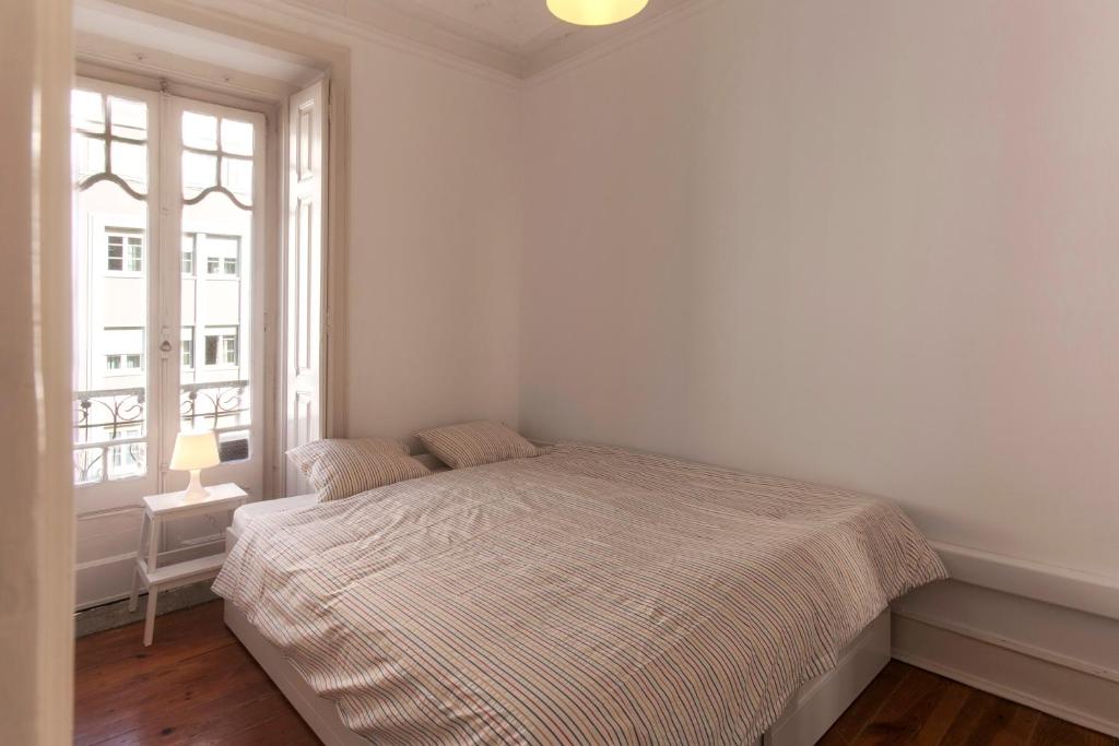 Postel nebo postele na pokoji v ubytování Lisbon City Center Apartment
