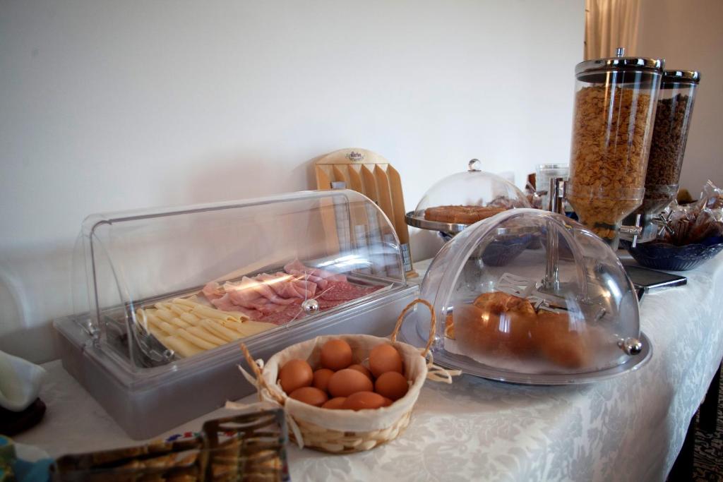a table topped with a buffet with eggs and food at Villa Margherita in Levanto