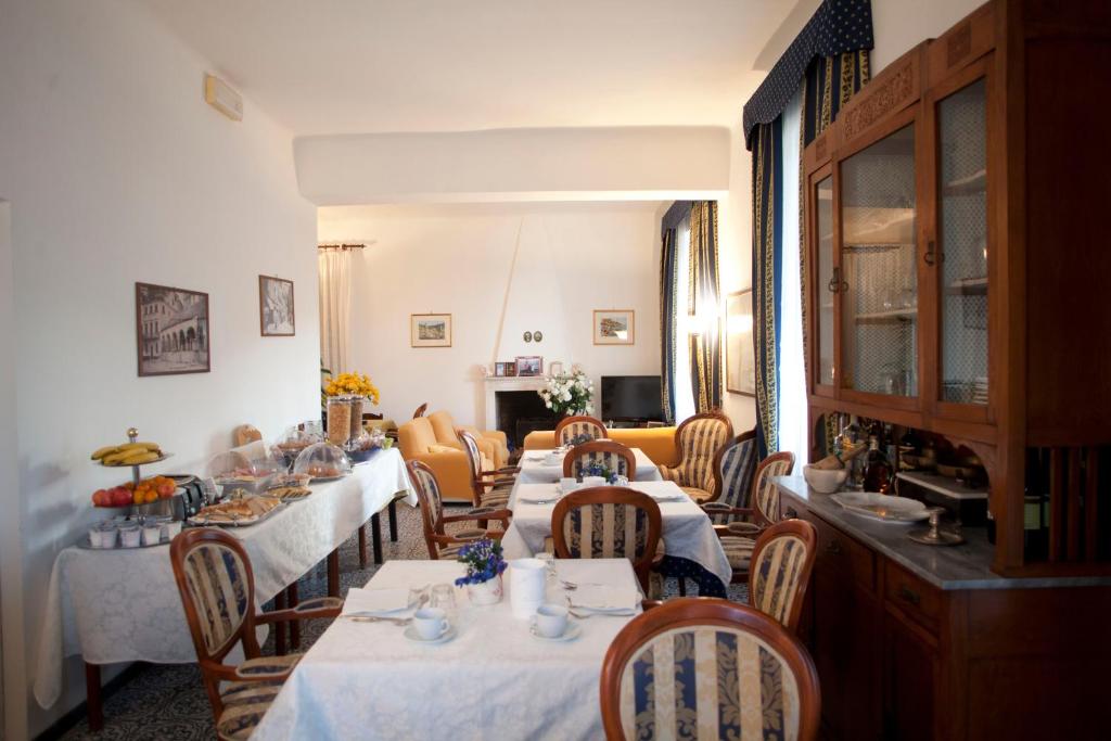 a dining room with tables and chairs in a room at Villa Margherita in Levanto