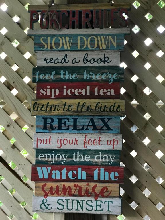 a sign that says slow down read a book feel the breeze stop tied tied tea at Ed & Rosie's Place in Black Mountain