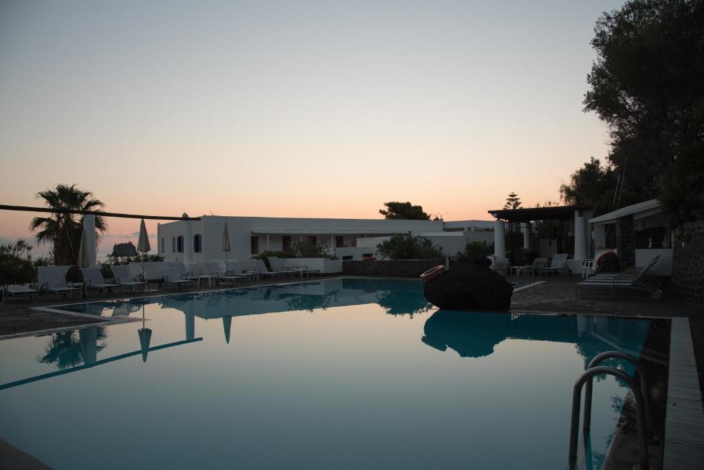 a view of a swimming pool at sunset at La Sirenetta Park Hotel in Stromboli