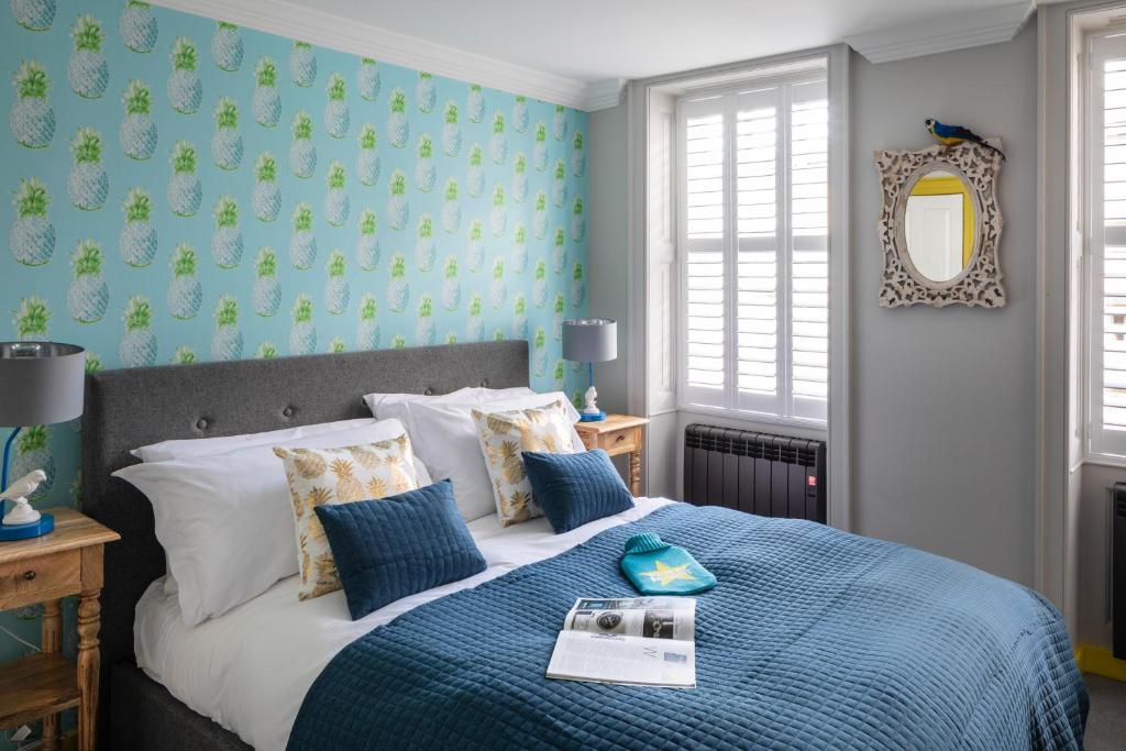 a bedroom with a large bed with a blue blanket at Dream Stays Bath - Kingsmead Street in Bath