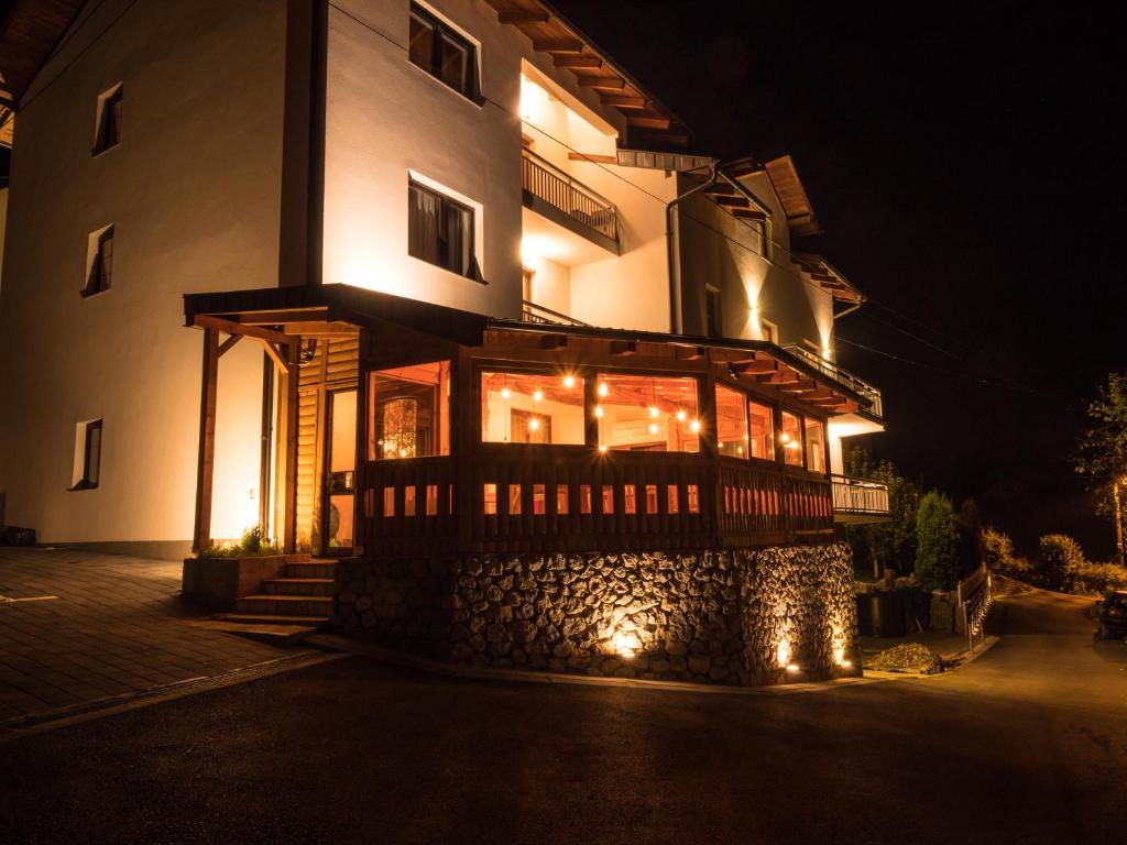 a building with lights on the side of it at night at Bergkranc Hotel & Resort in Pale