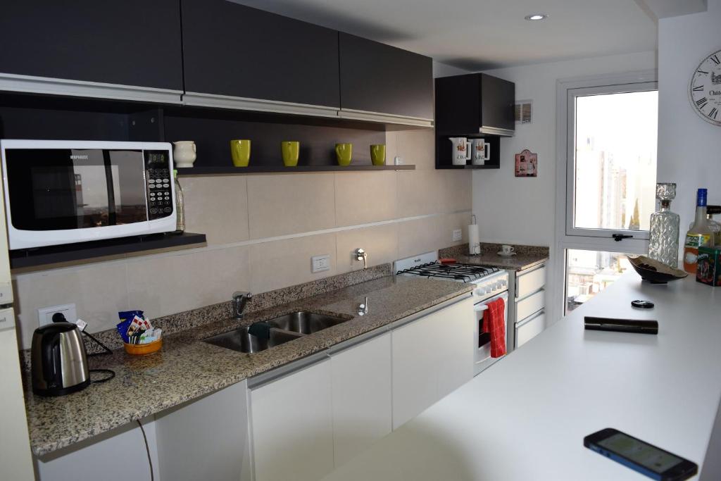 a kitchen with a sink and a microwave at Apartamento en el centro de Banfield in Banfield