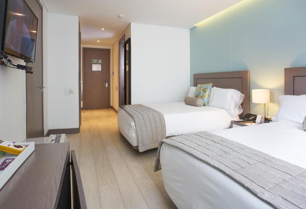 Postel nebo postele na pokoji v ubytování Hotel 100 Luxury Suites by Preferred
