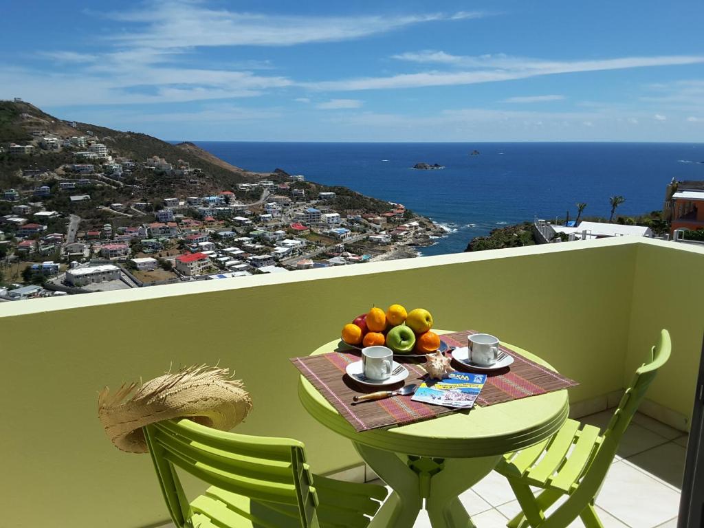 
a table topped with chairs sitting on top of a beach at Bay View condo in Philipsburg
