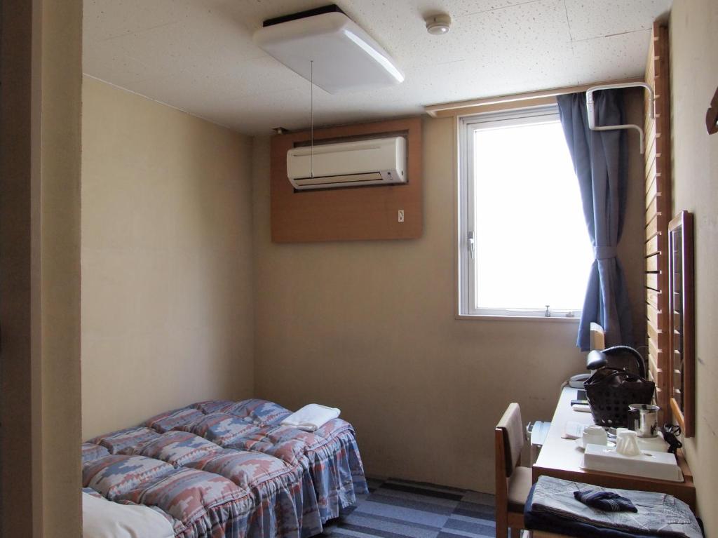 Postel nebo postele na pokoji v ubytování Tsukuba Daily Inn