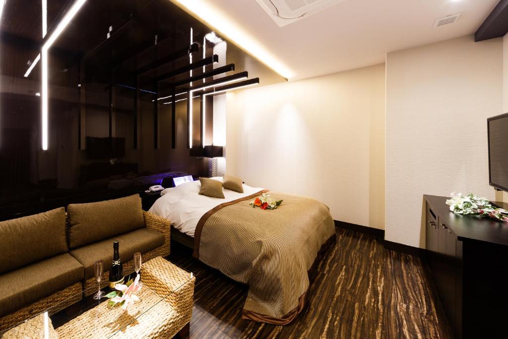 Postel nebo postele na pokoji v ubytování HOTEL MYTH-Resort -ホテル マイス リゾート- adult only