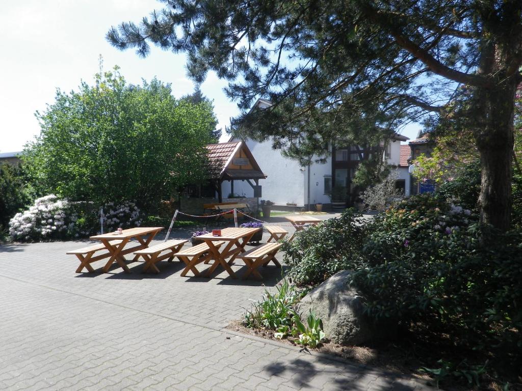 a group of picnic tables with a gazebo at Zum Sudhaus im Herzen der Schorfheide in Golzow