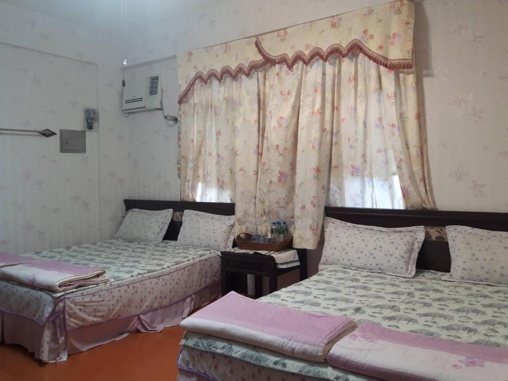 Postel nebo postele na pokoji v ubytování Dai Yi Shia B&B