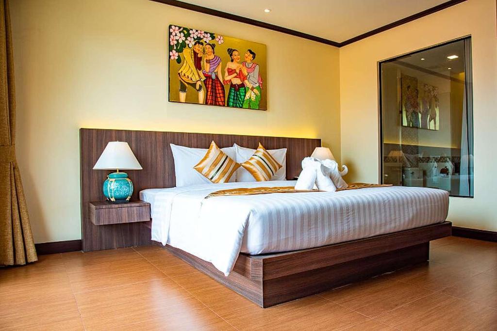Postel nebo postele na pokoji v ubytování The LD Pattaya Hotel