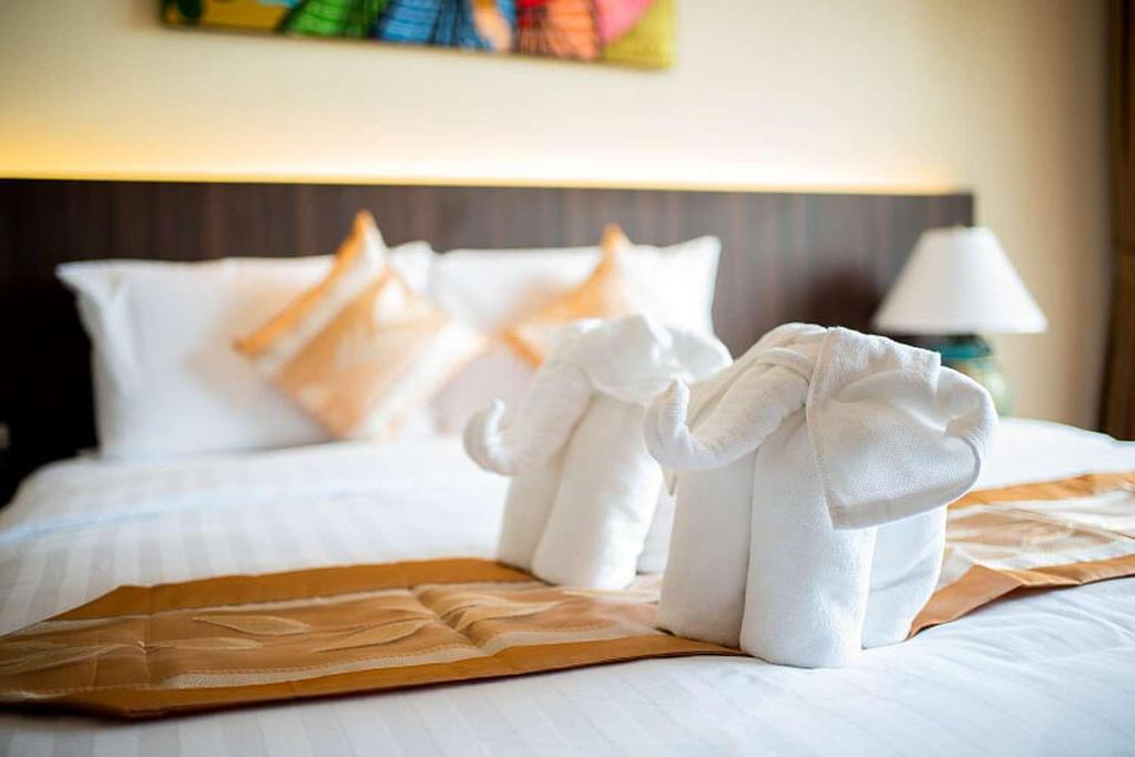 Postel nebo postele na pokoji v ubytování The LD Pattaya Hotel