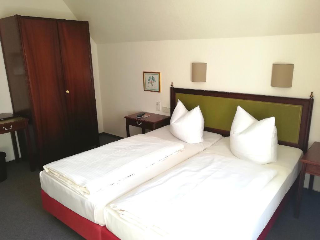 Postel nebo postele na pokoji v ubytování Hotel Krohwinkel
