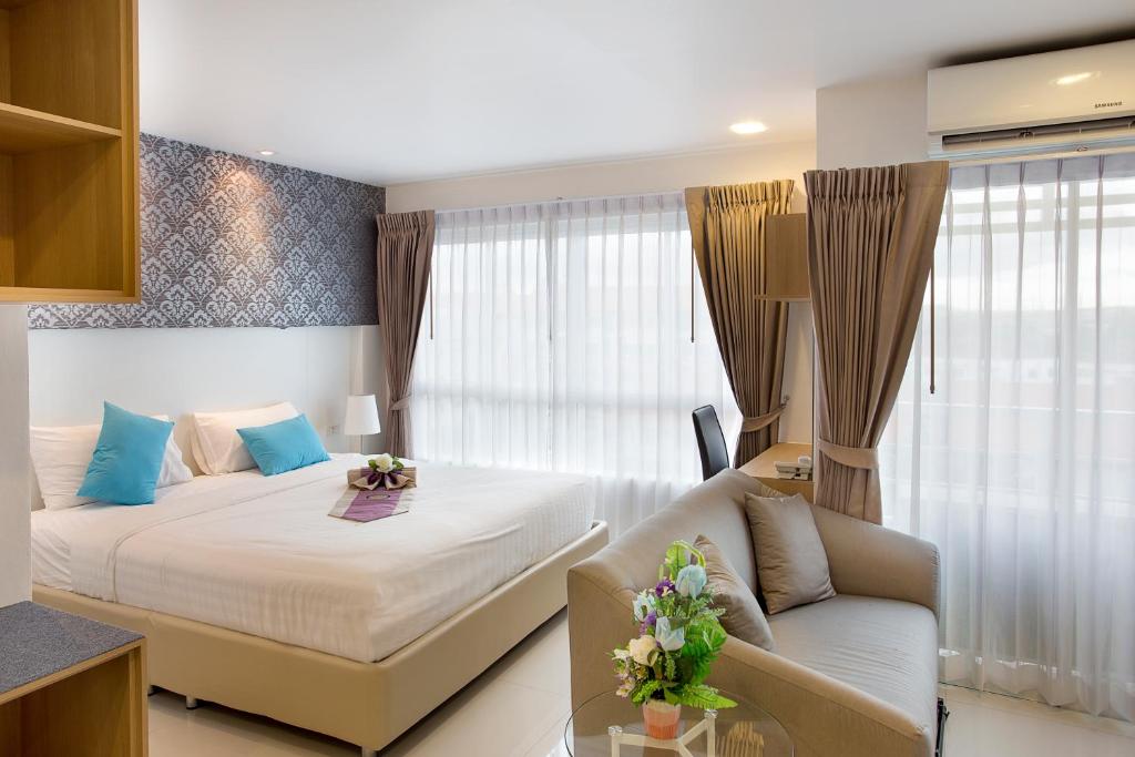 Postel nebo postele na pokoji v ubytování C-House & Residence Hotel Amata City