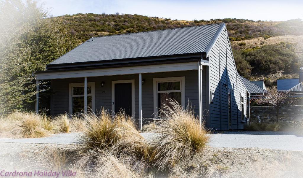 a small house with a hill in the background at Cardrona Holiday Villa in Cardrona