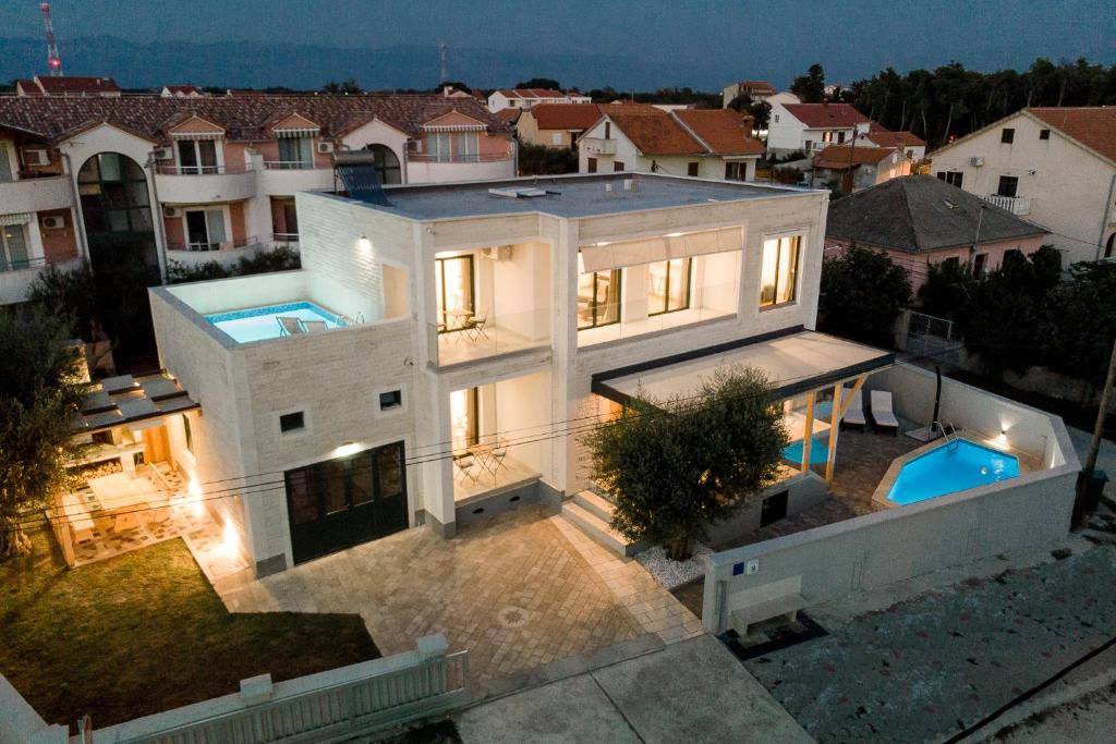 an aerial view of a house with a swimming pool at Villa Privlaka in Privlaka