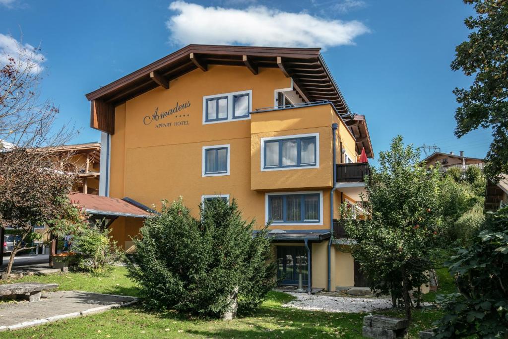 a building with a sign on the side of it at Amadeus Appartement in Sankt Johann in Tirol