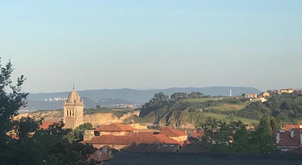 Vistas a una ciudad con una torre y una iglesia en Calle Quinta, 3, en Luanco
