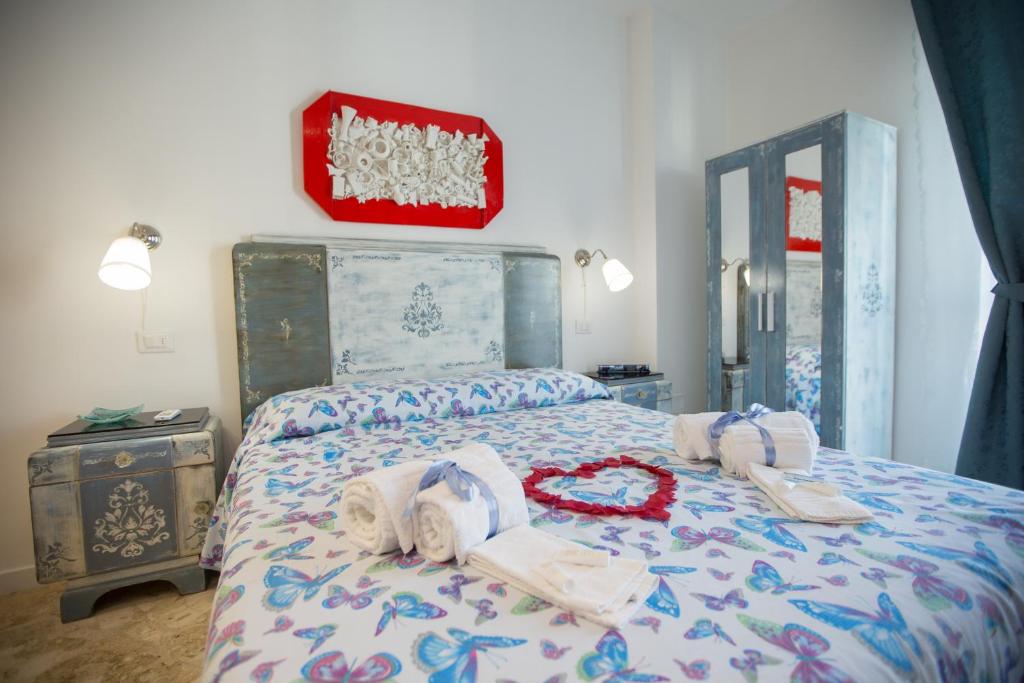a bedroom with a bed with towels on it at Versomare in Polignano a Mare