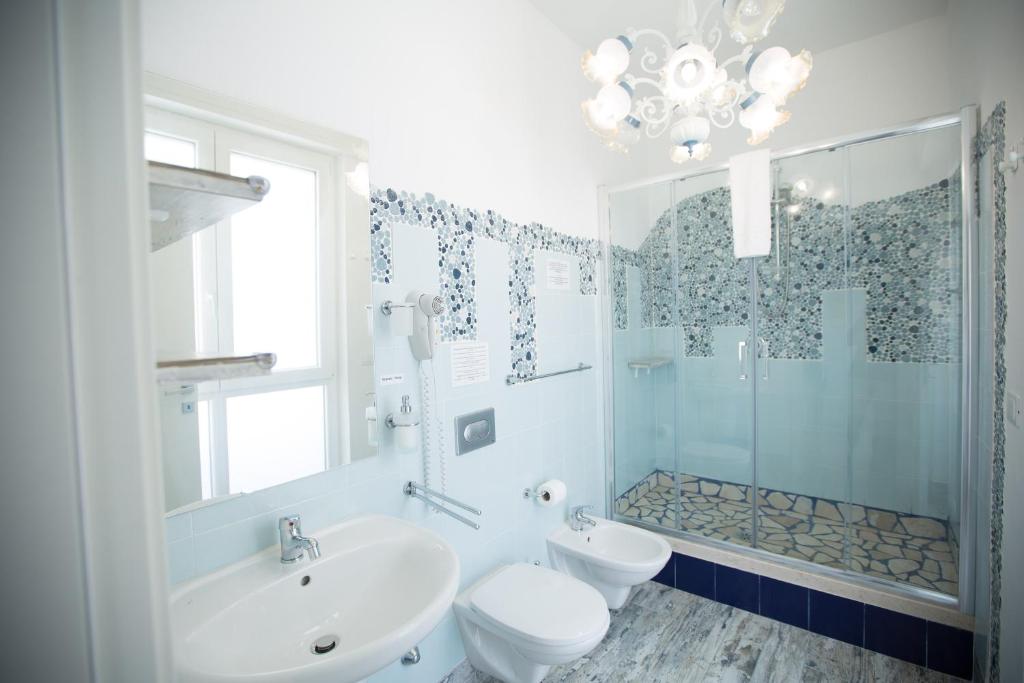 a bathroom with a sink and a toilet and a shower at Versomare in Polignano a Mare