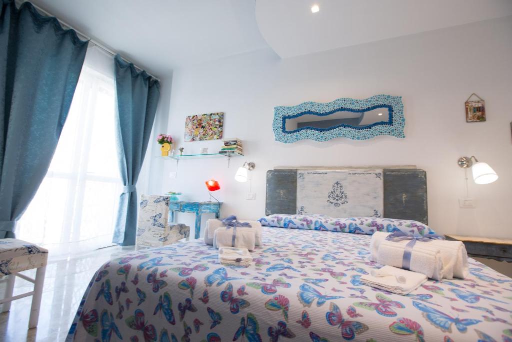 a bedroom with a bed with a comforter on it at Versomare in Polignano a Mare