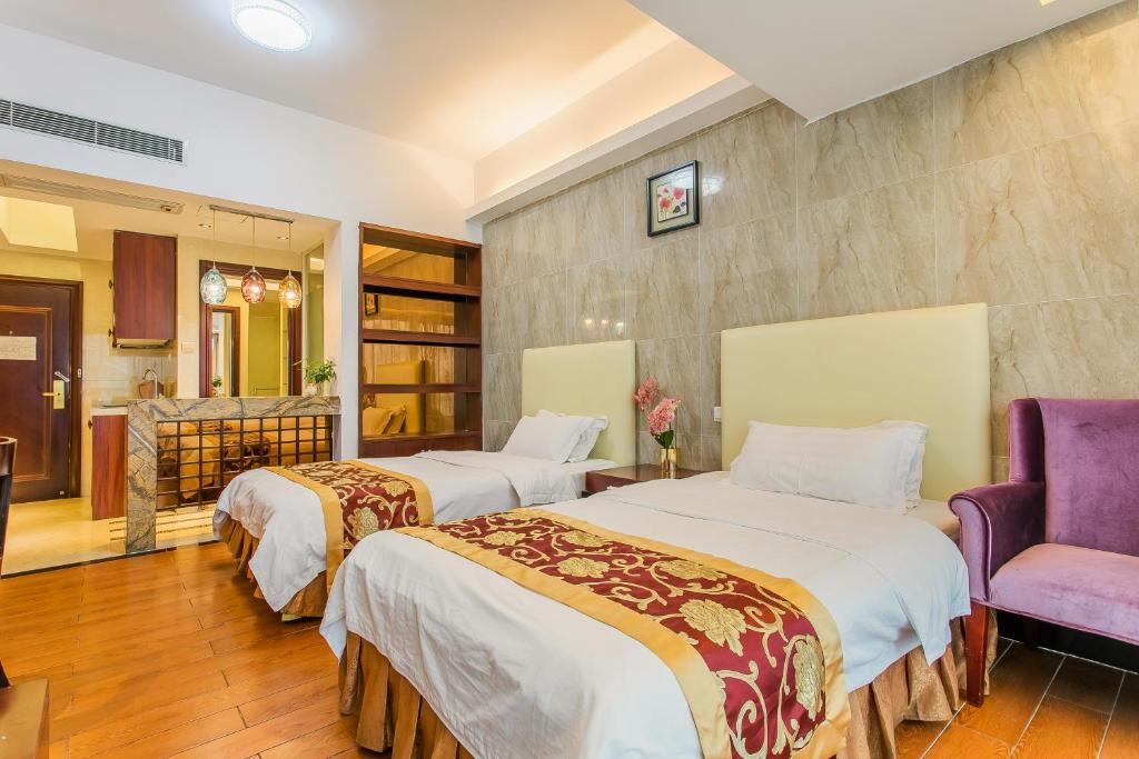 Ein Bett oder Betten in einem Zimmer der Unterkunft Grand Continental Apartment