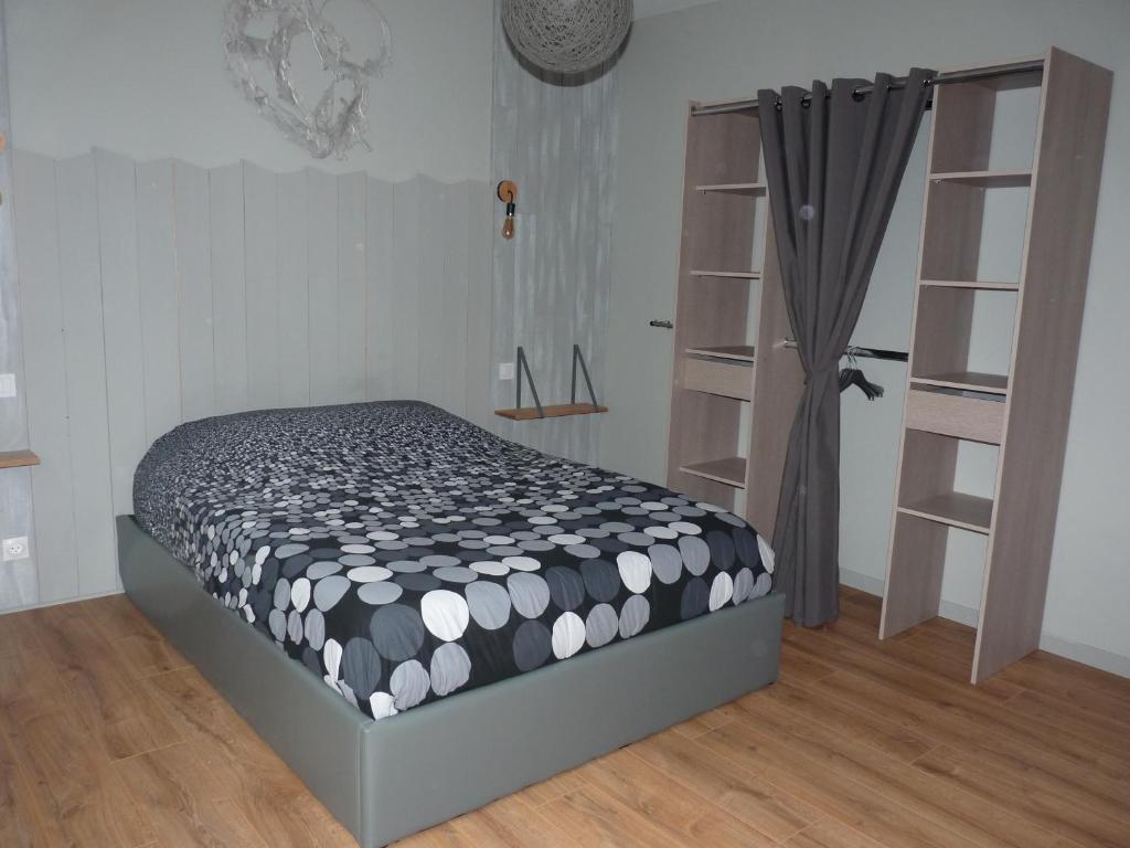 オルブールにあるAu Petit Bonheur Charmant Gite Colmarのベッドルーム1室(ベッド1台、白黒の掛け布団付)