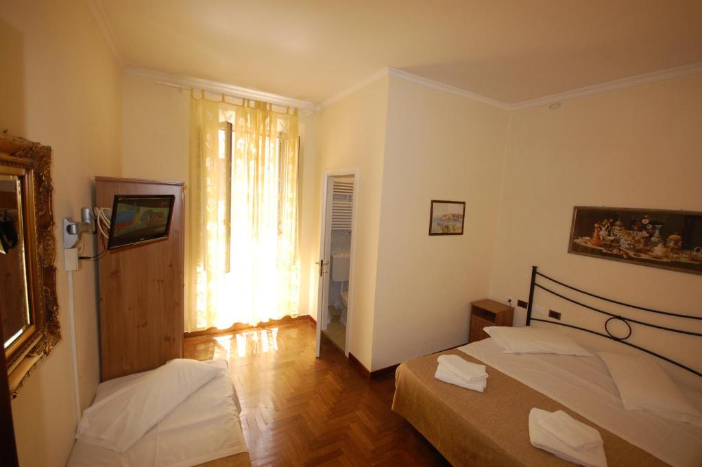 Postel nebo postele na pokoji v ubytování Hotel Alexis