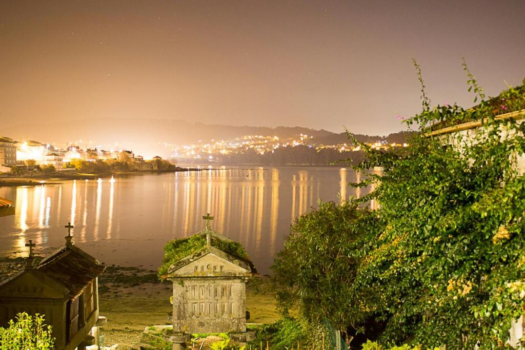 a view of a body of water at night at Casa Do Pazo in Combarro