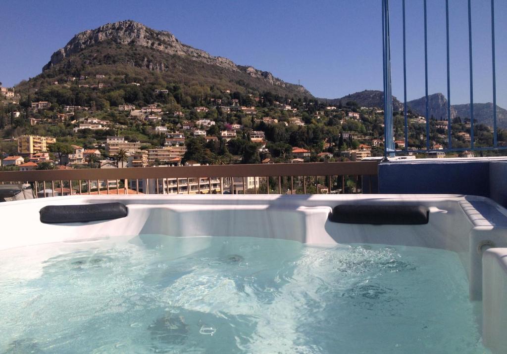 a hot tub with a view of the golden gate bridge at Hotel Diana in Vence