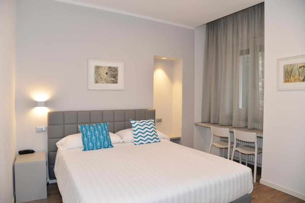 Postel nebo postele na pokoji v ubytování Hotel Quarcino