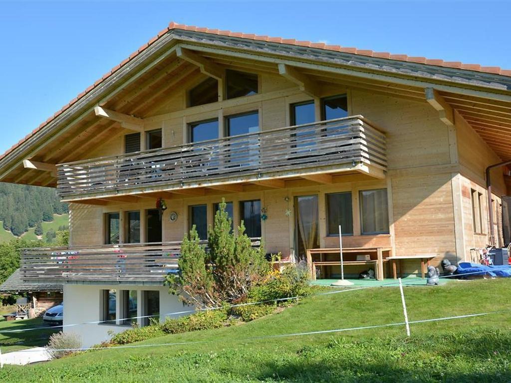 a large house with a balcony on the side of it at Apartment Alpha by Interhome in Zweisimmen