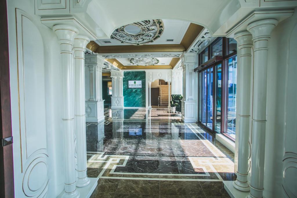 a hallway of a building with white columns at Emerald Hotel Baku in Baku