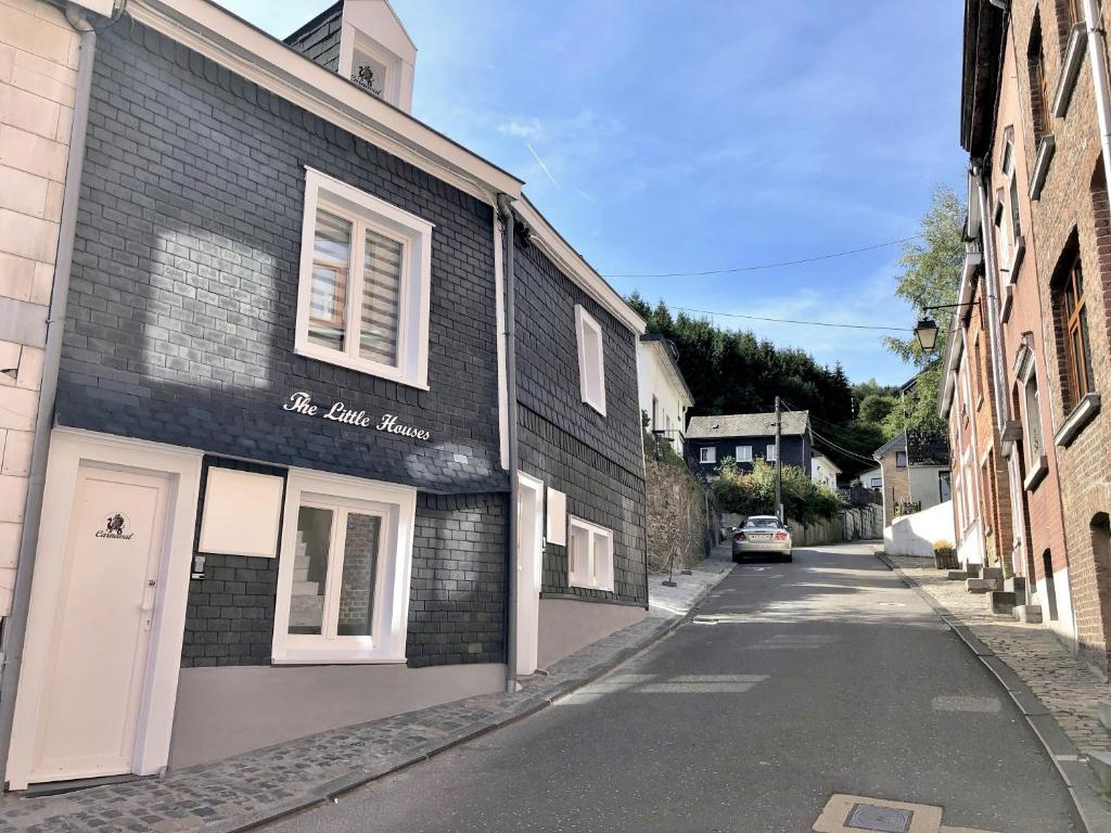 a building with a sign on the side of a street at The Little Houses - Malmedy - in Malmedy