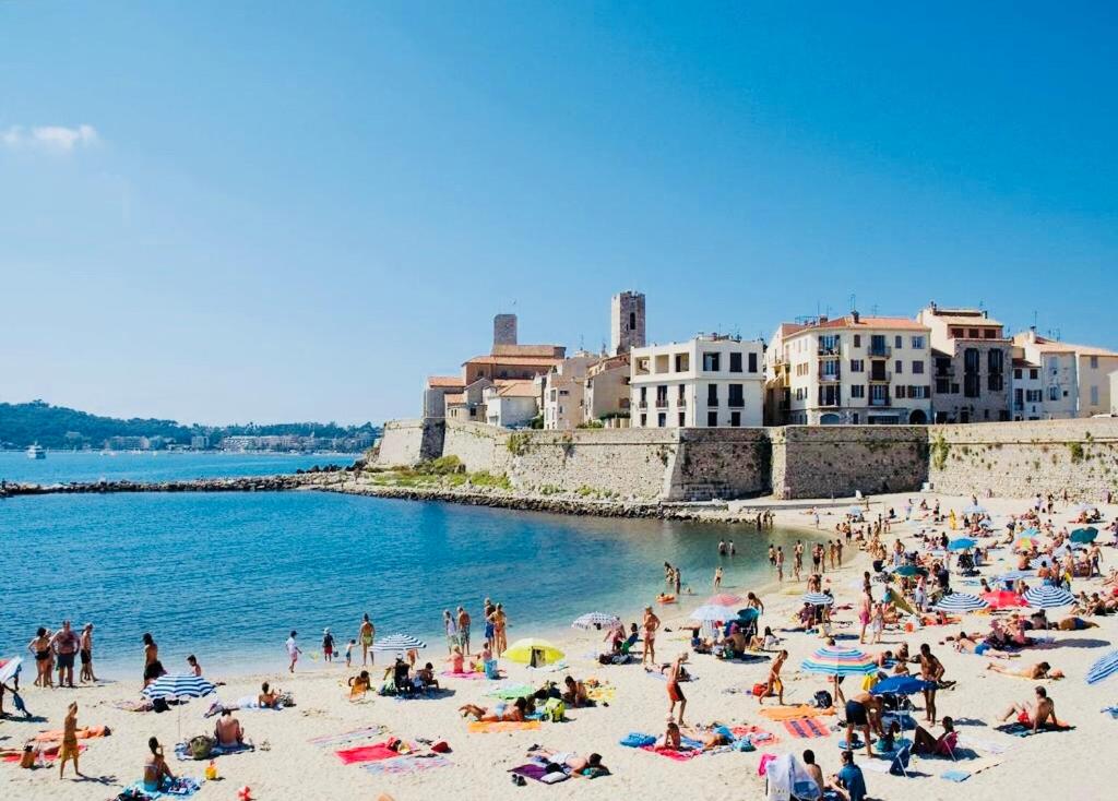 un grupo de personas en una playa cerca del agua en Appt moderne Vieil Antibes 3 pièc, en Antibes