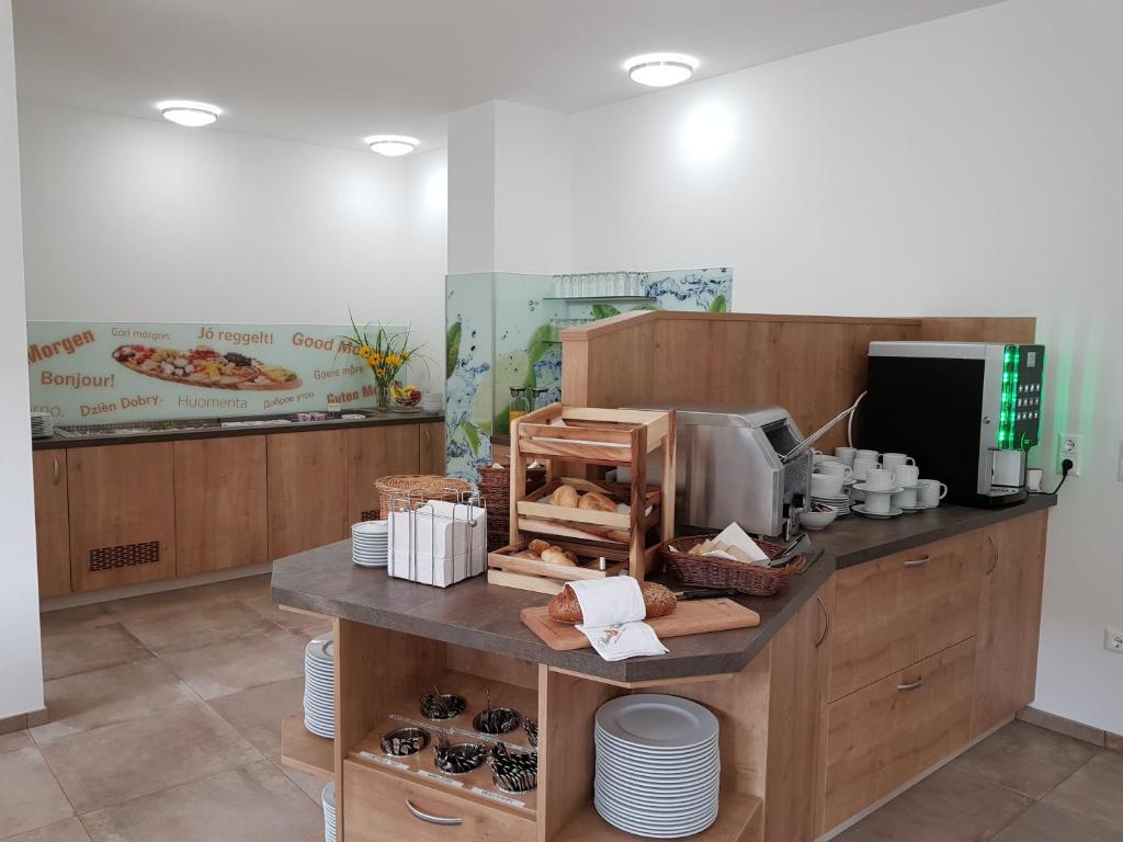 a bakery with a counter with doughnuts on it at Hotel Rimo in Ort im Innkreis