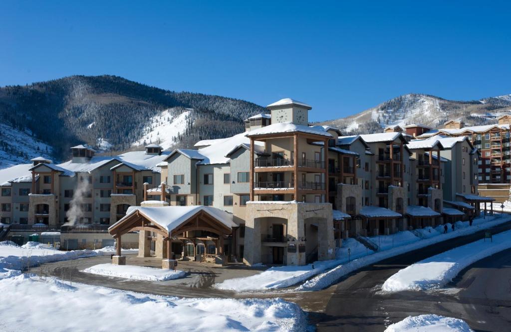 a snow covered ski slope with houses and cars at Silverado Lodge Park City - Canyons Village in Park City