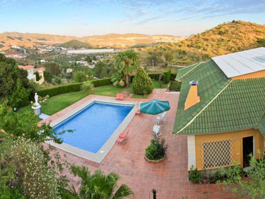 an aerial view of a house with a swimming pool at Holiday Home La Poza by Interhome in Campanillas