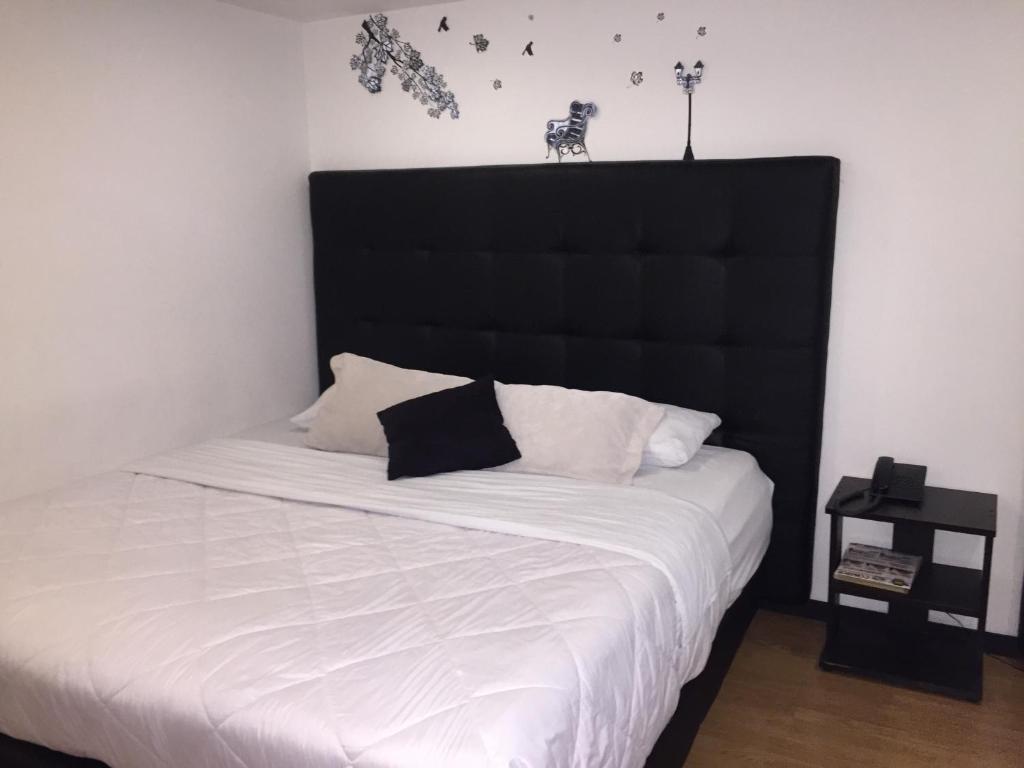 Postel nebo postele na pokoji v ubytování Hotel Montecarlo Boutique