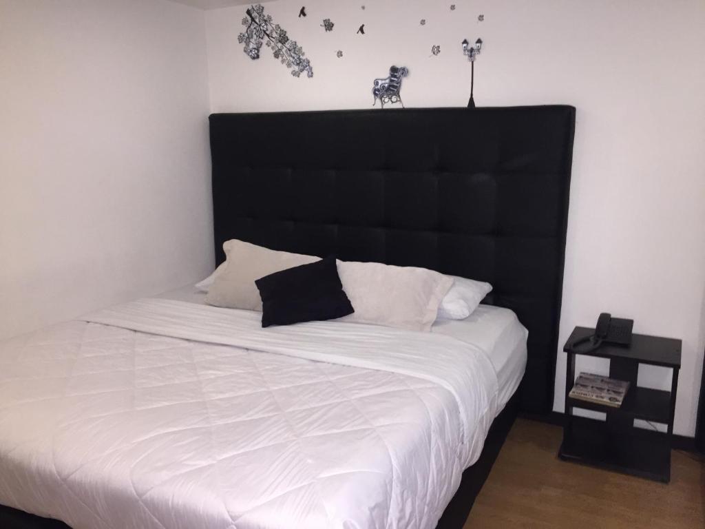 Postel nebo postele na pokoji v ubytování Hotel Montecarlo Boutique