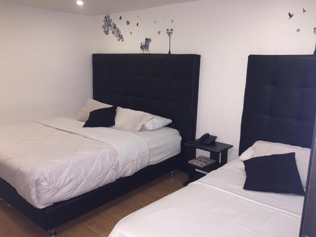 Postel nebo postele na pokoji v ubytování Hotel Montecarlo Boutique