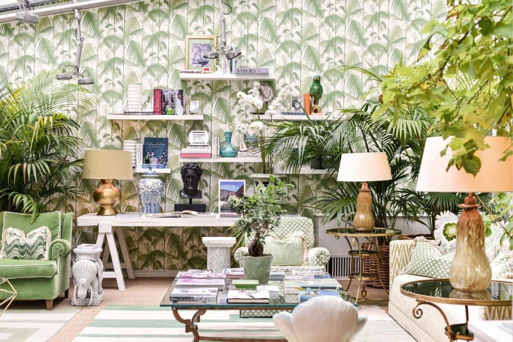 a room with plants and a desk and chairs at Hotel Van Cleef in Bruges