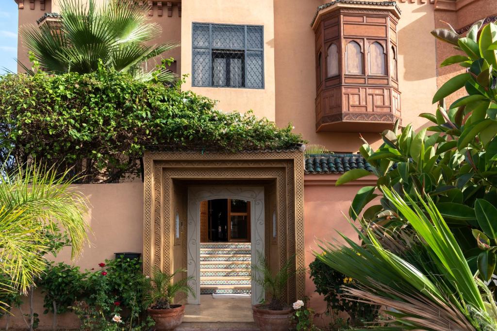 an entrance to a building with plants in front of it at Hôtel Riad Airport Marrakech in Marrakech